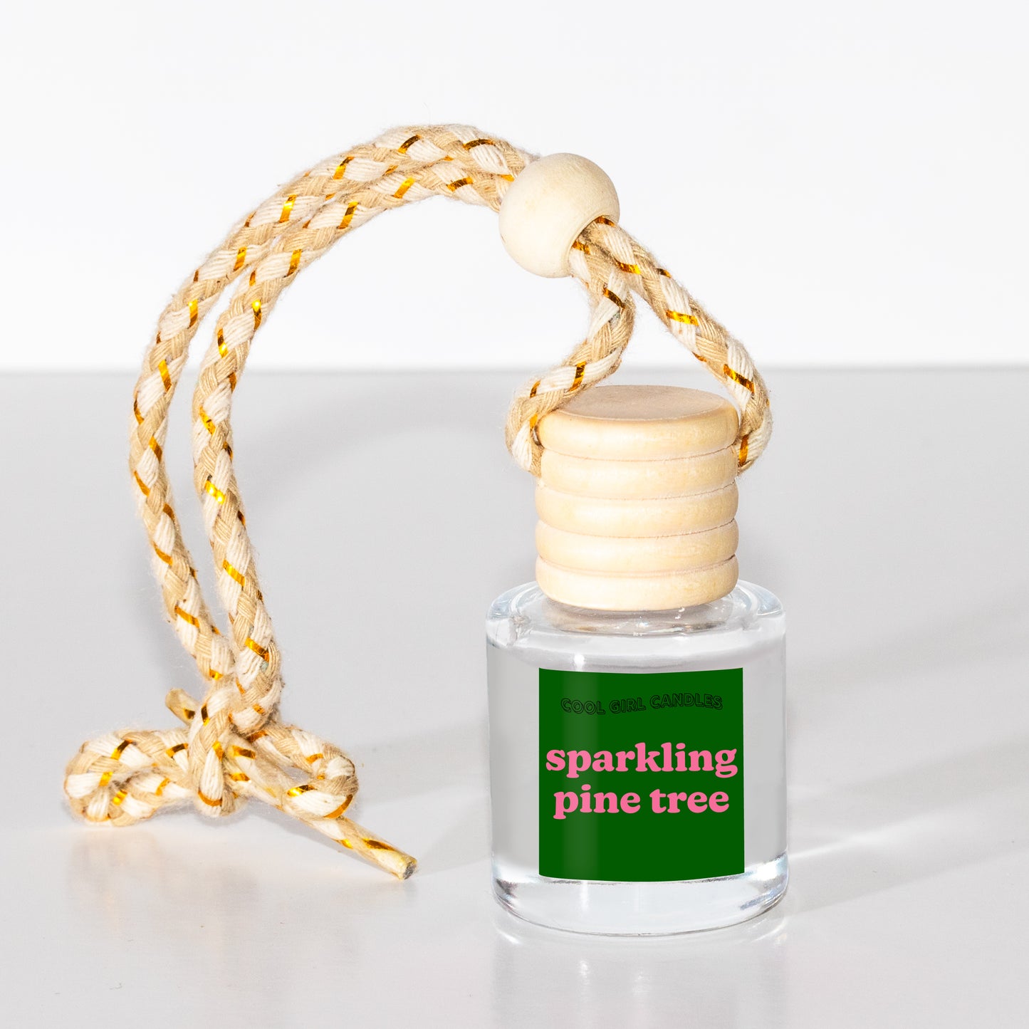 holiday car freshener that smells like a christmas tree made by cool girl candles
