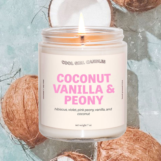 coconut vanilla and peony candle by cool girl candles is a fun, summer coconut candle featuring soft floral notes to round out this scent profile. It's giving an island getaway wearing flowers in your hair