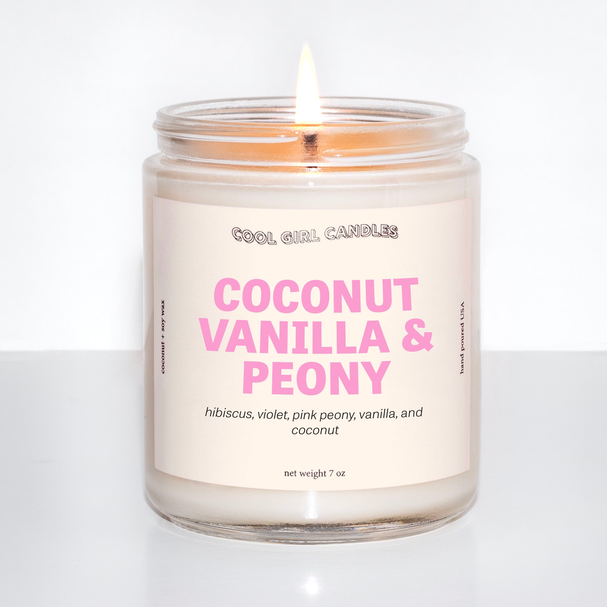 coconut vanilla and peony candle by cool girl candles is a fun, summer coconut candle featuring soft floral notes to round out this scent profile. It's giving an island getaway wearing flowers in your hair
