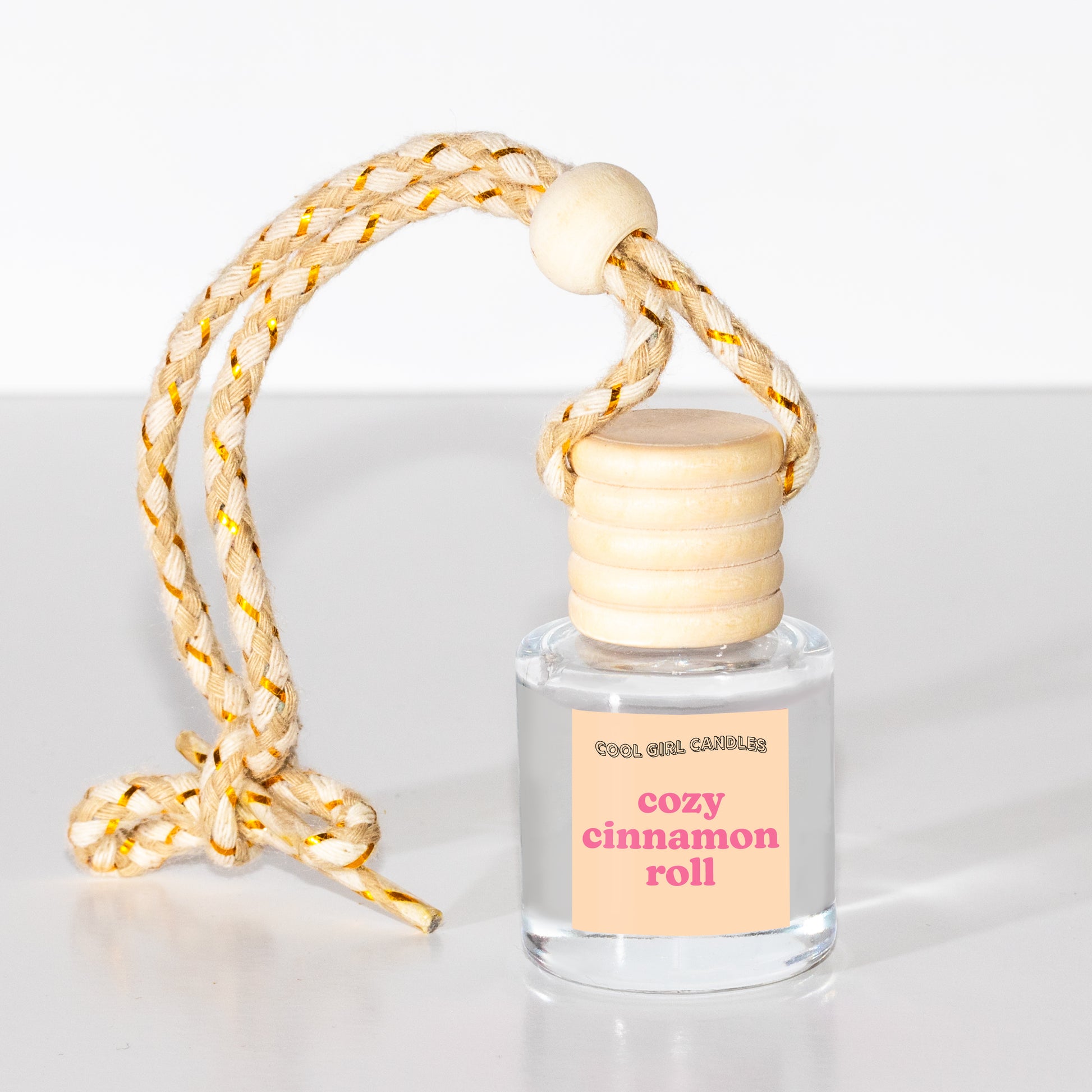 Winter and holiday scented car freshener that smells like cozy cinnamon rolls made by cool girl candles