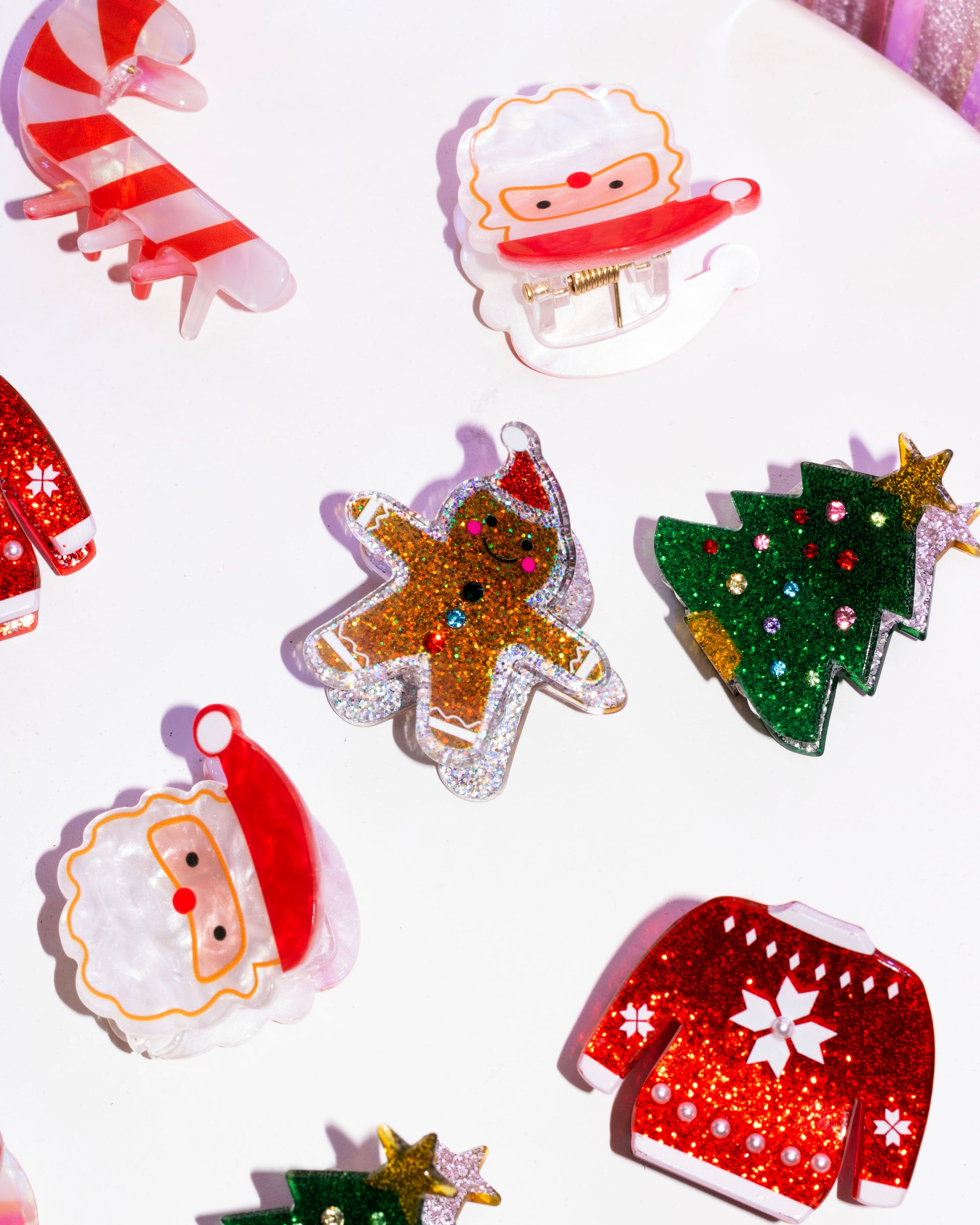 Fun Festive Hair Clips For Christmas Holidays featuring a Santa Claus head, gingerbread man, sparkly christmas tree, and ugly Christmas sweater