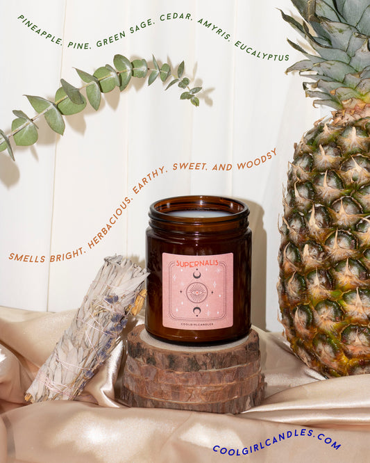 cedar candle for fall. Supernalis is a fall scented candle that features pineapple, pine, green sage, cedar, eucalyptus and more. From small women owned indie business cool girl candles. 