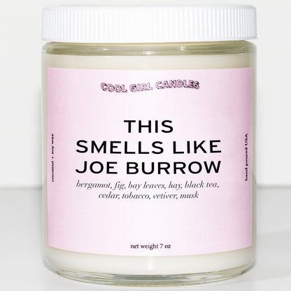 A pastel pink candle that says this smells like joe burrow from cool girl candles. A sports gift for anyone who loves joe burrow, the Cincinnati Bengals quarterback football player 